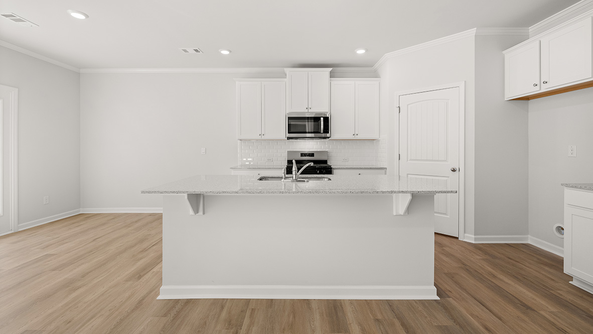 Interior kitchen with center island and white cabinets