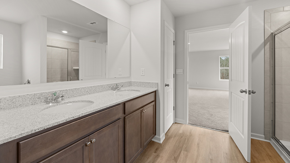 Interior primary bathroom with double sink and shower