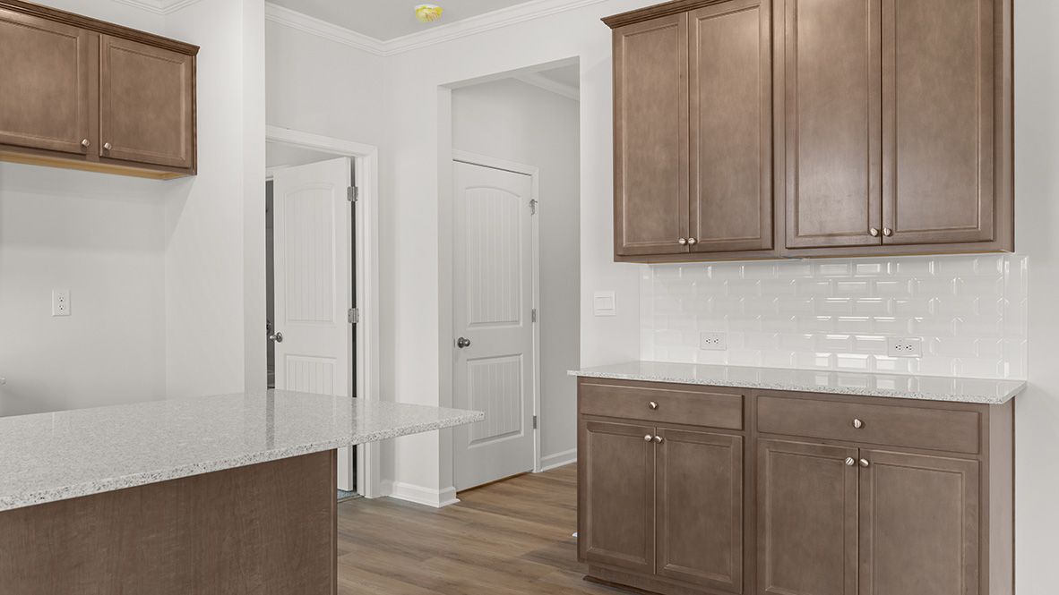 Interior kitchen with center island and wooden cabinets