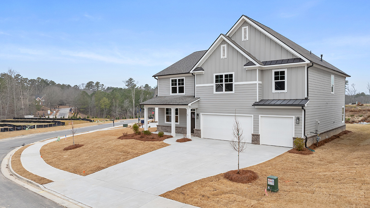 Exterior light grey two-story home with stone detailing