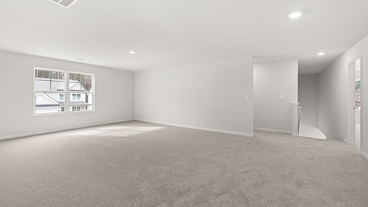 Interior upstairs loft area with large windows