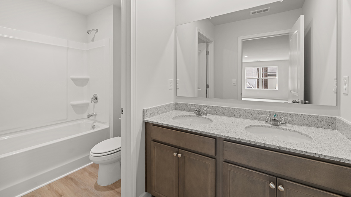 Interior bathroom with double sink and full-sized shower