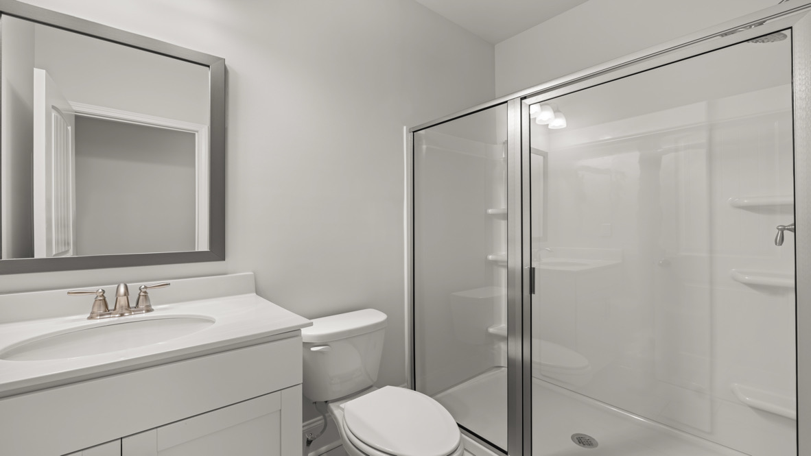 New House secondary full bathroom in Hamptons at Riverwood includes vanity, hard surface countertop, and storage cabinetry crafted by D.R. Horton