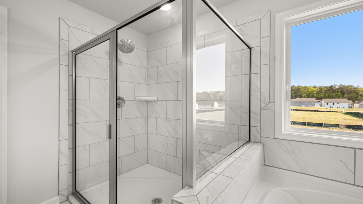 New Build Home en suite with practical vanity space, durable tile floors, and direct connection to the owner’s suite