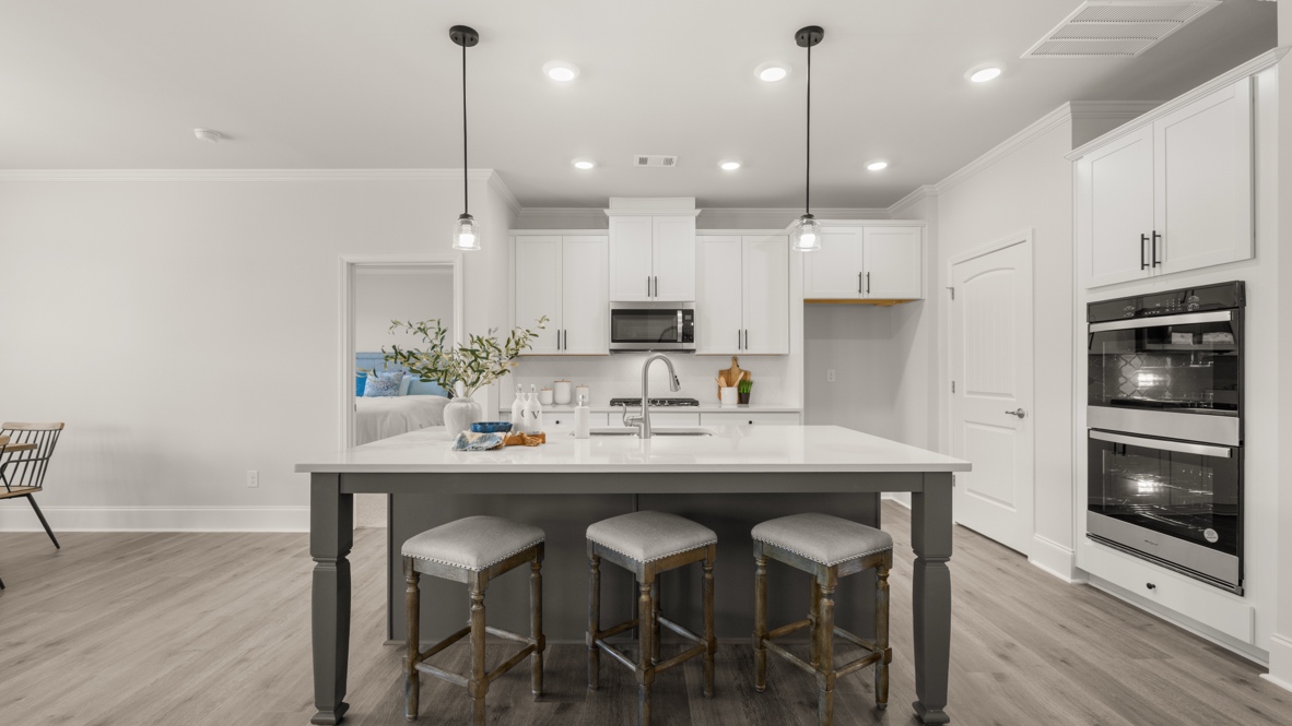 Interior kitchen with center island and white cabinets