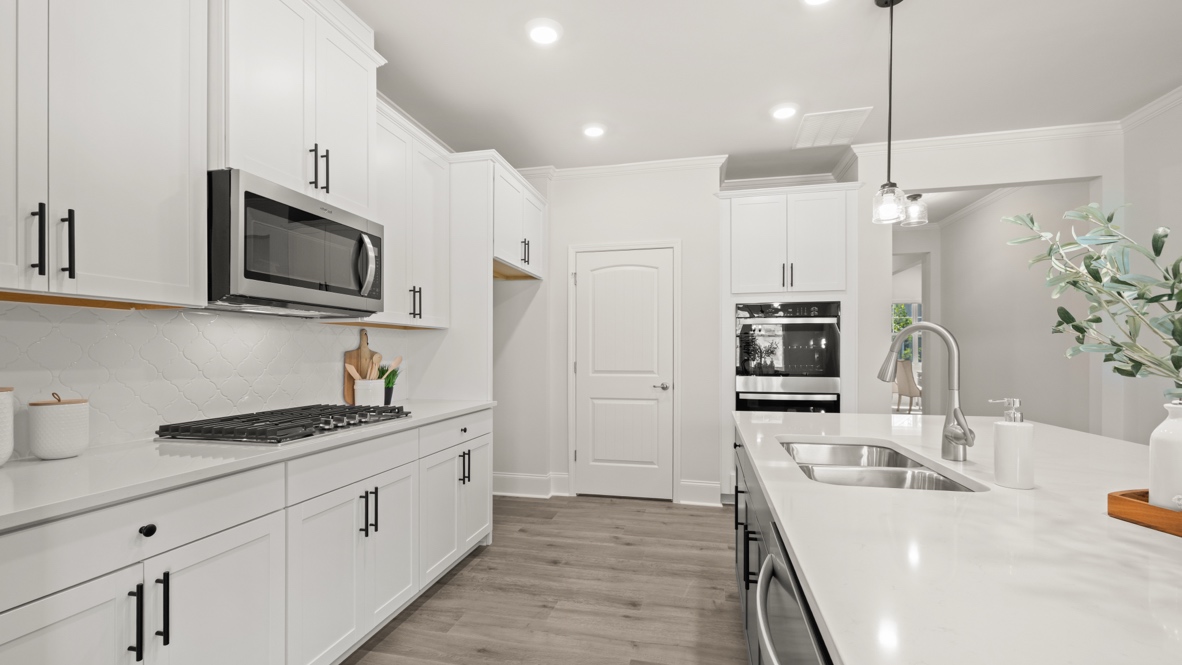 full kitchen with white cabinets with hardware