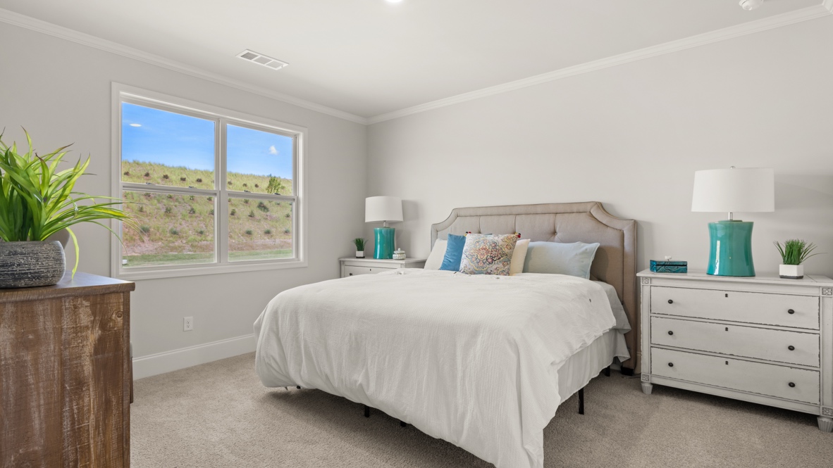 Primary bedroom with two windows.
