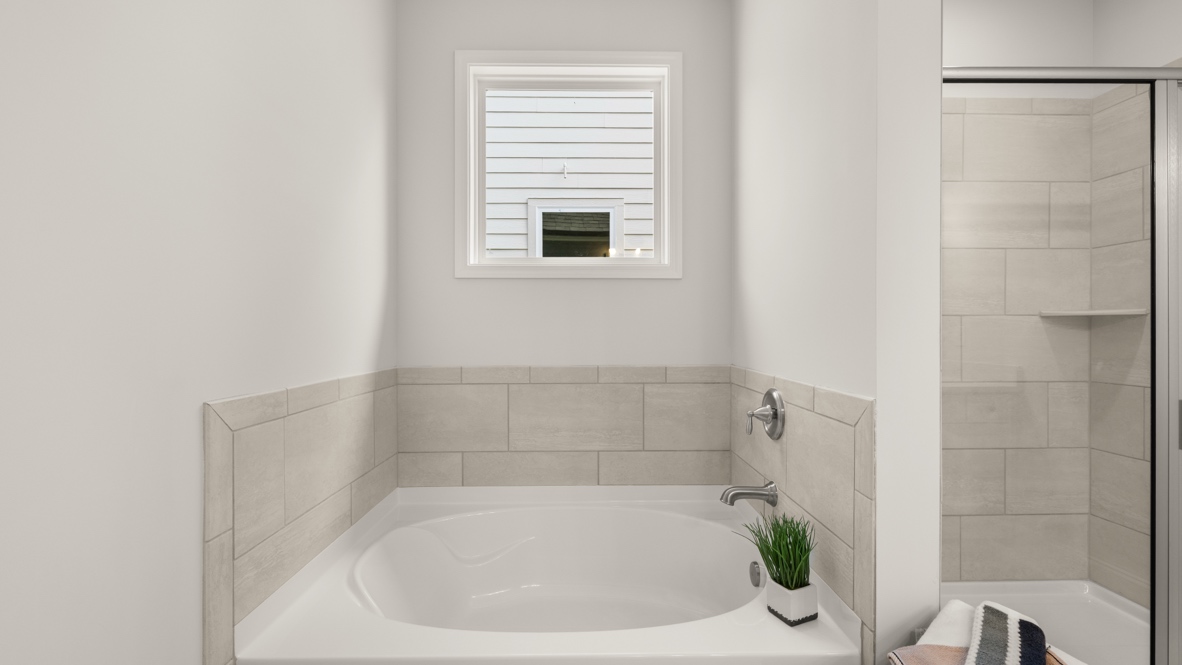 primary bathroom with soaking tub and separate shower