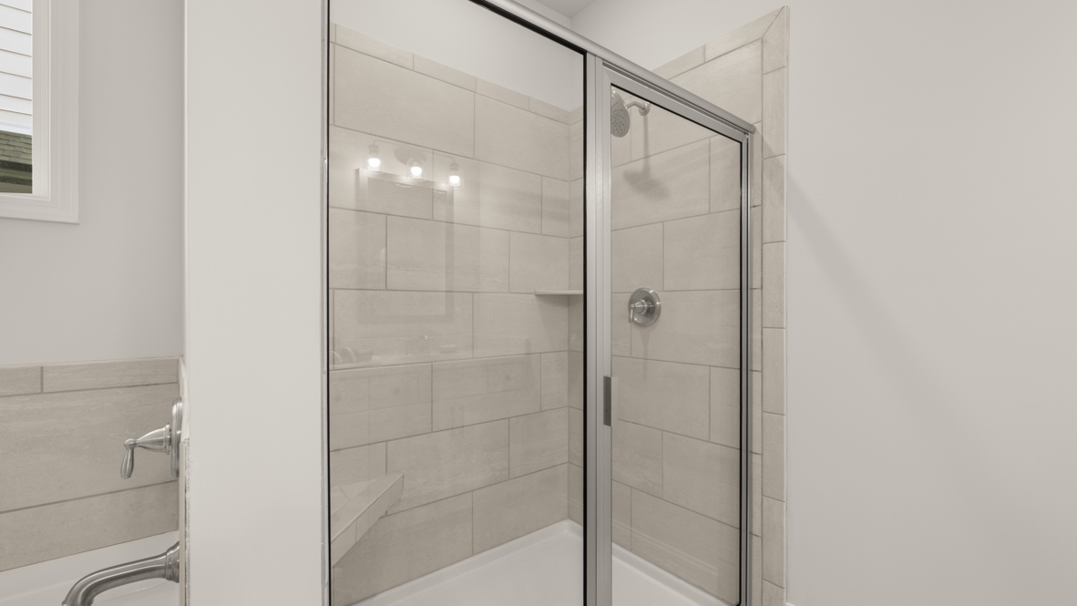 primary bathroom with soaking tub and separate shower