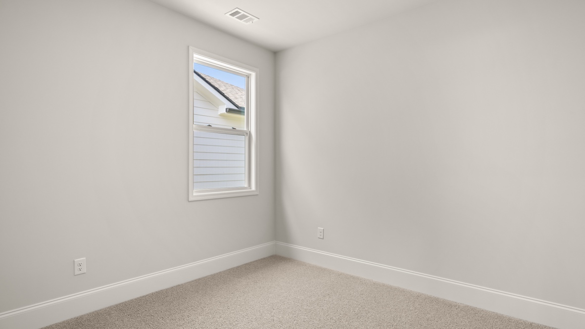 Bedroom with closet and door to hallway.