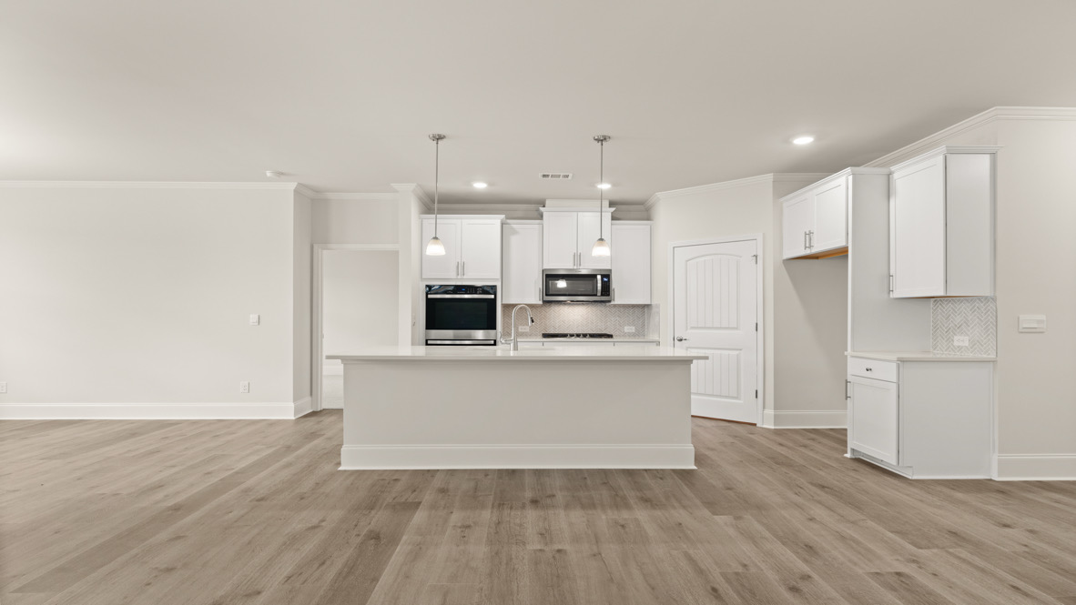 Interior kitchen with center island and white cabinets