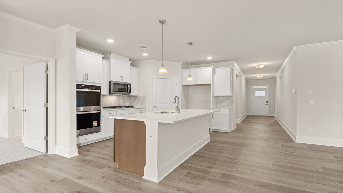 Interior kitchen with center island and white cabinets