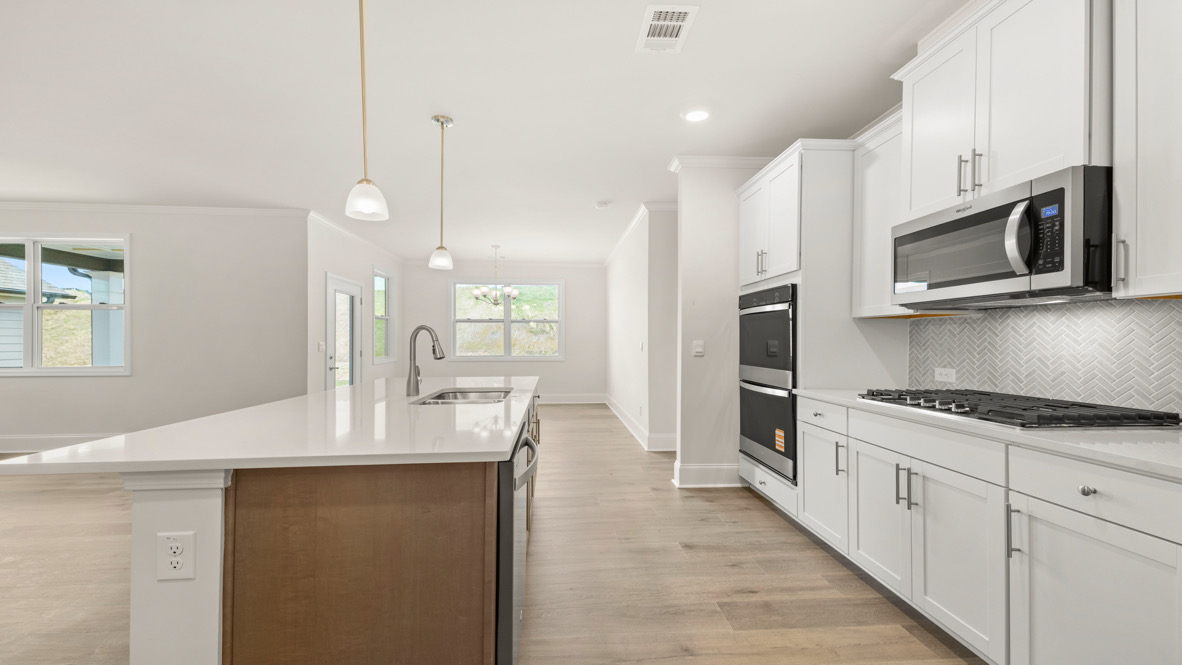 Interior kitchen with center island and white cabinets