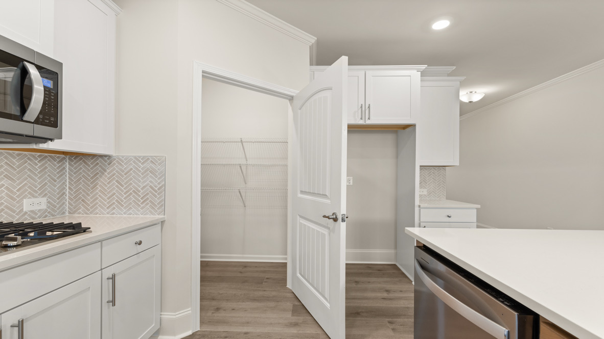 Interior kitchen with center island and white cabinets