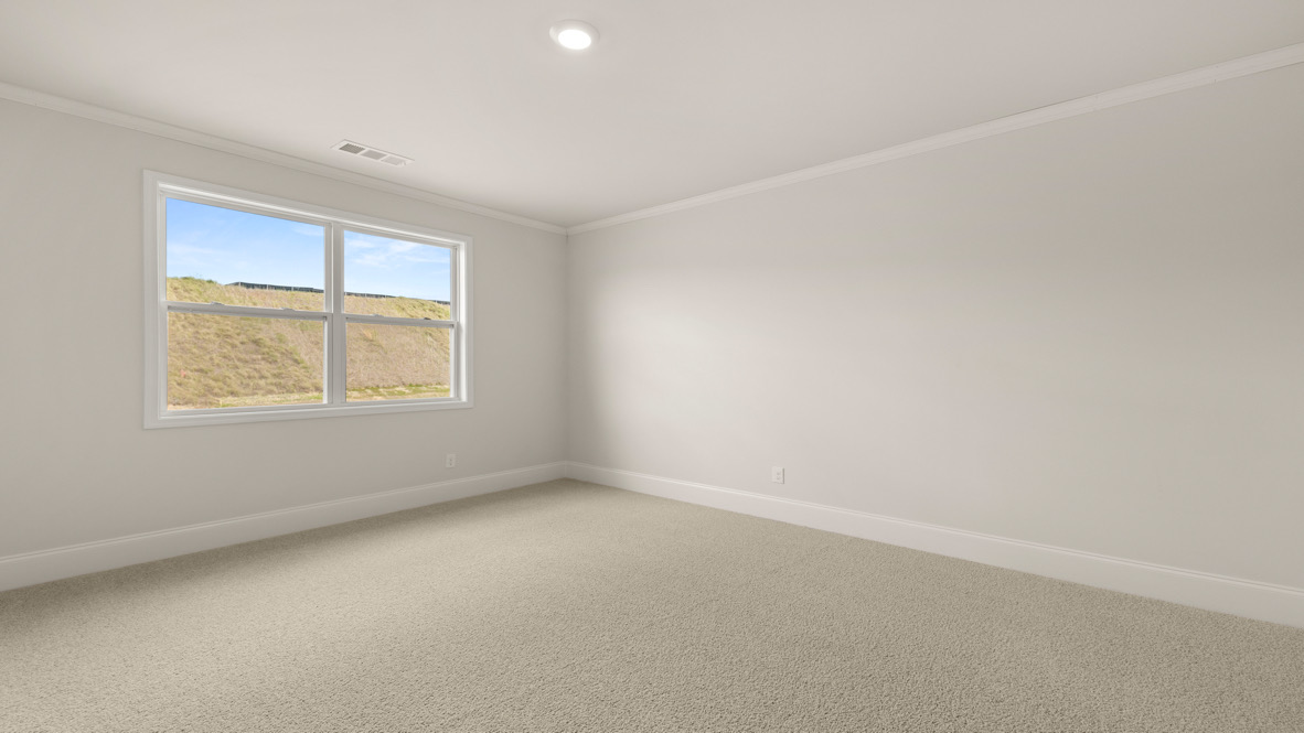 Interior primary bedroom with large window