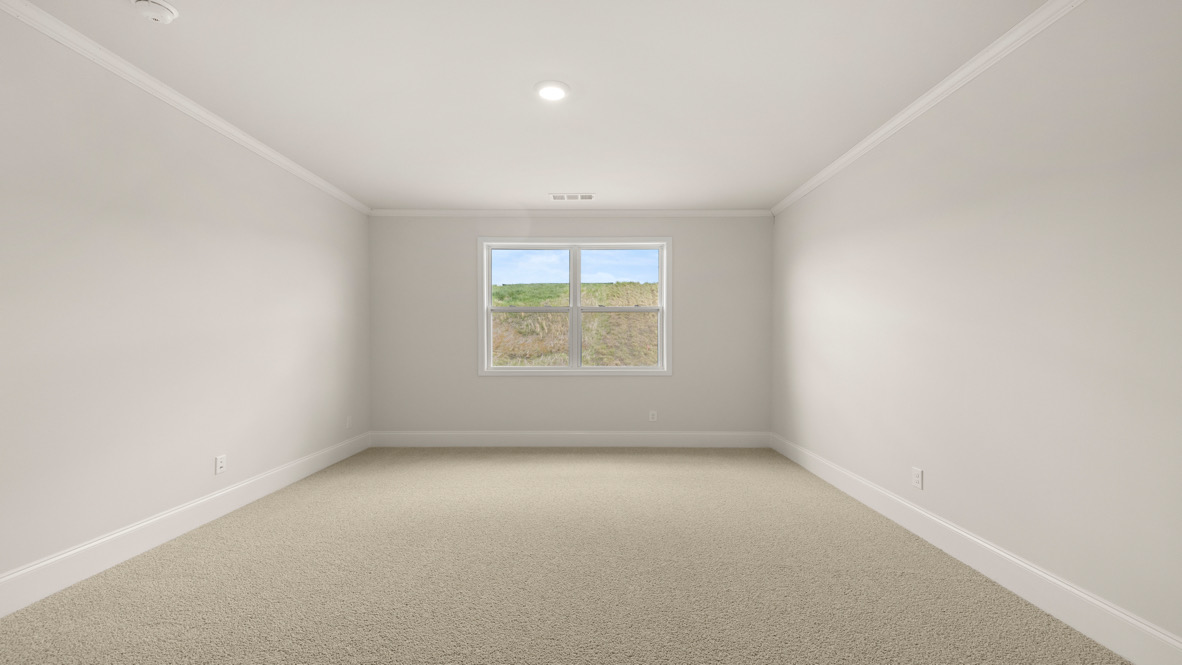 Interior primary bedroom with large window