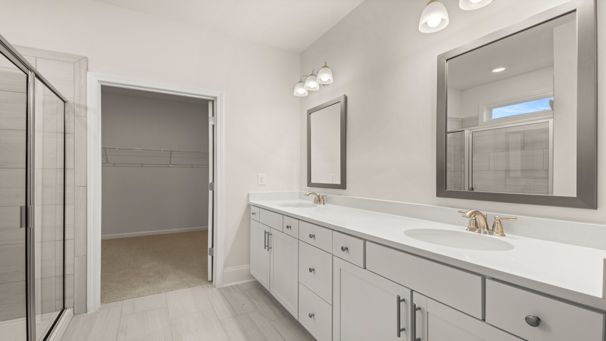 Interior primary bathroom with double sink and shower