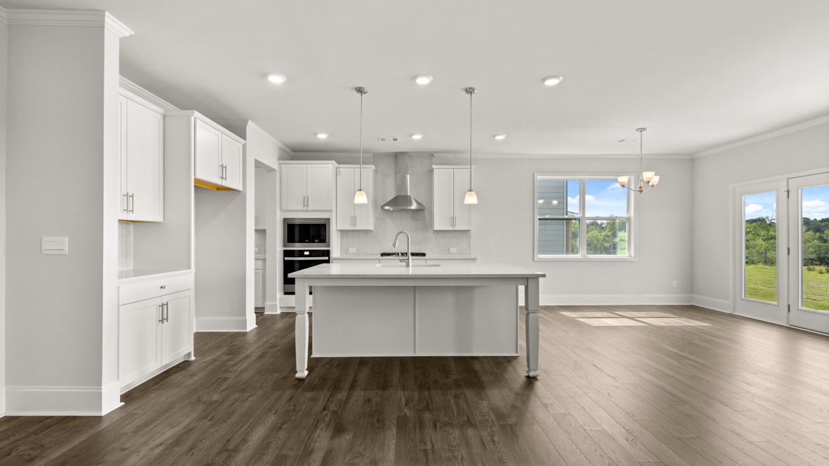 Interior kitchen with center island and white cabinets