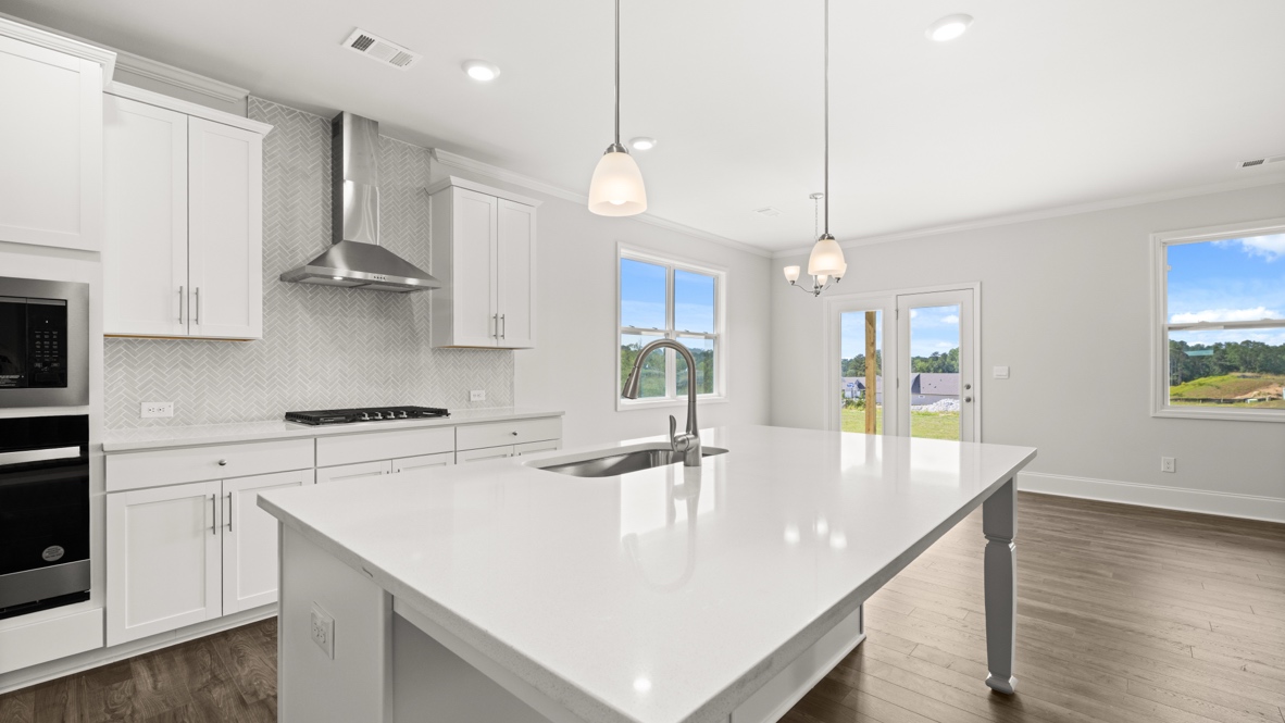 Interior kitchen with center island and white cabinets