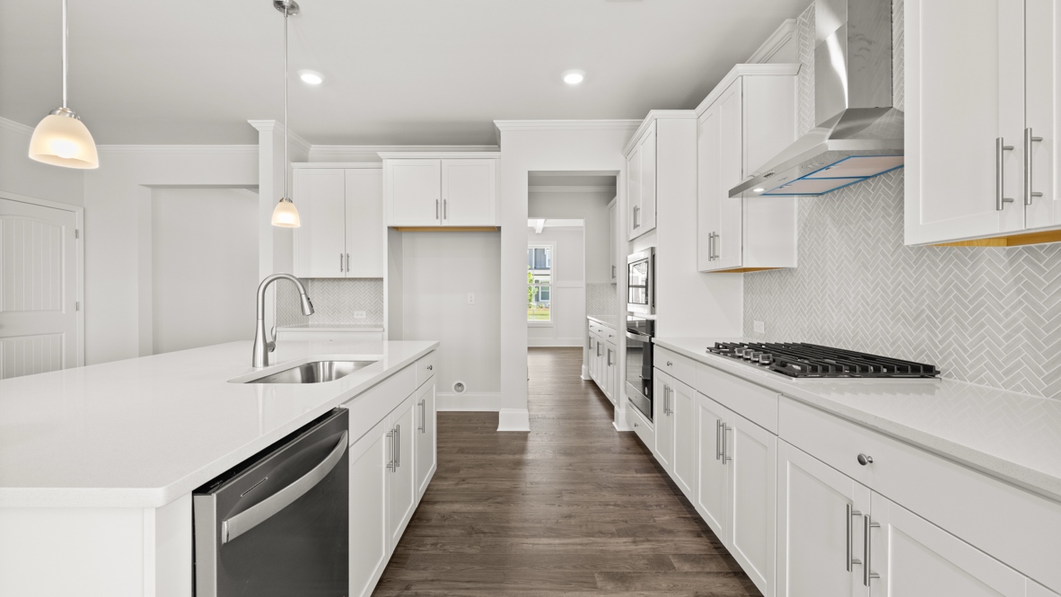 Interior kitchen with center island and white cabinets