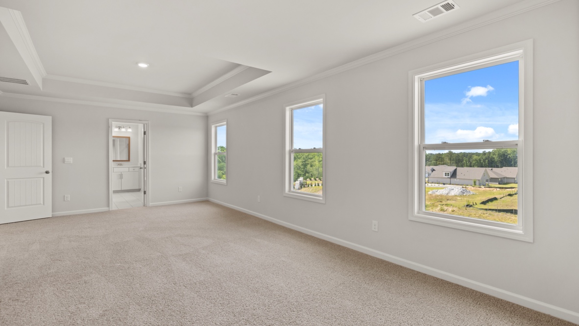 Interior primary bedroom with windows