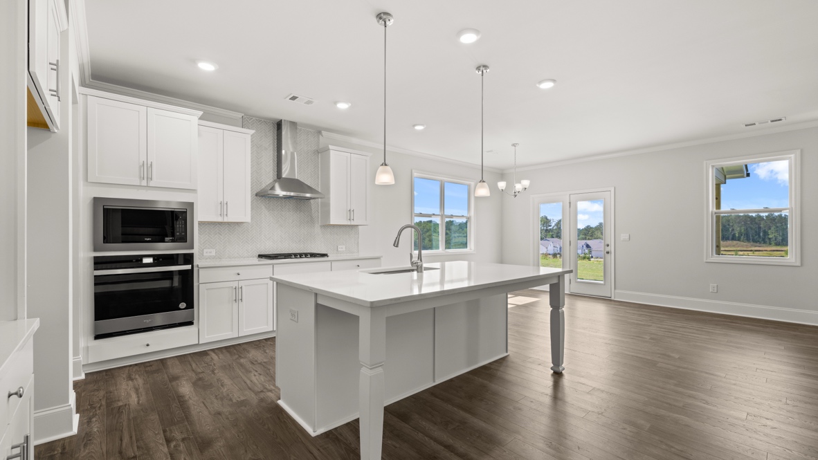 Interior kitchen with center island and white cabinets