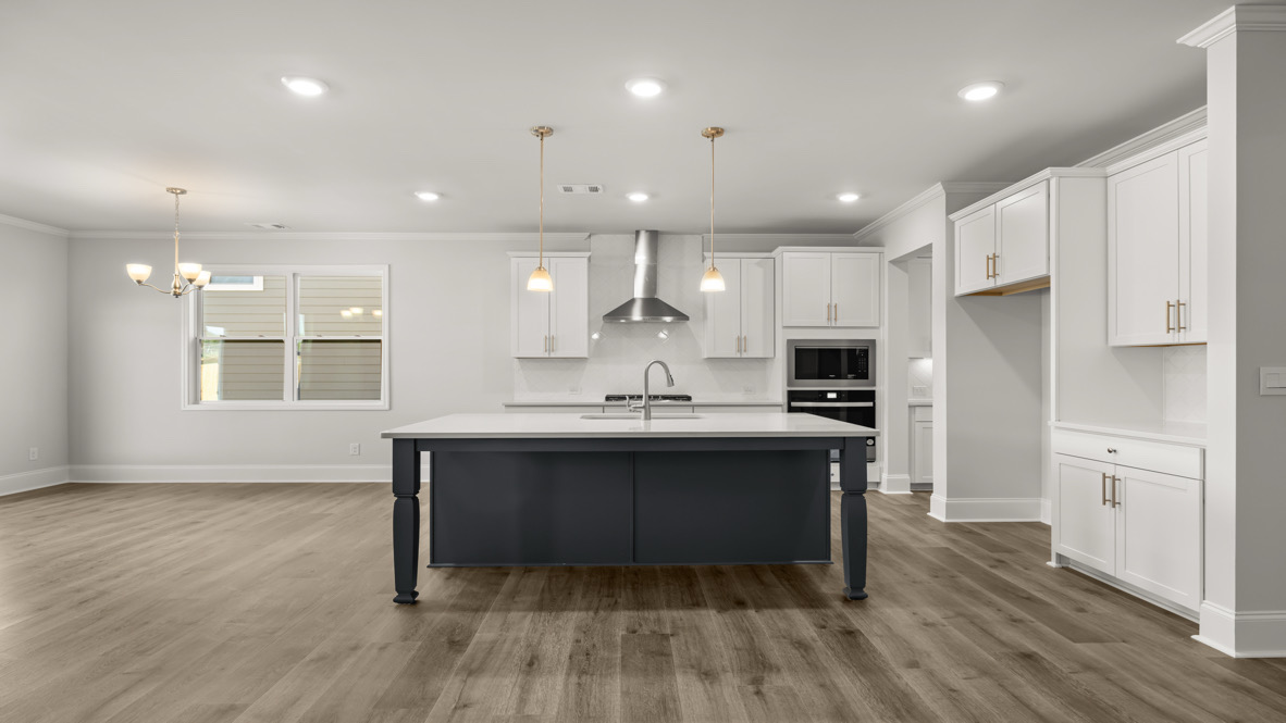 Interior kitchen with center island and white cabinets