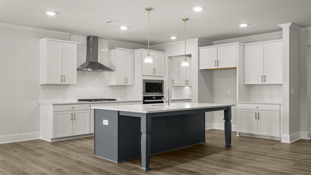 Interior kitchen with center island and white cabinets