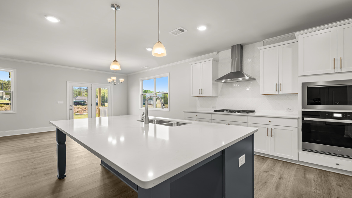 Interior kitchen with center island and white cabinets