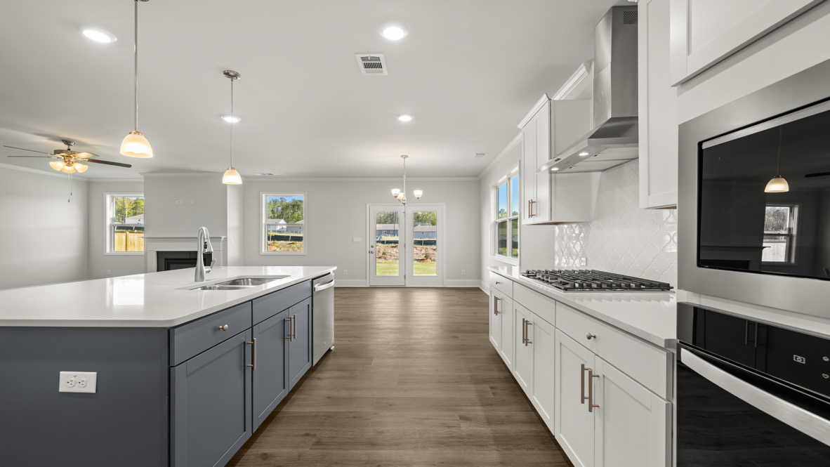 Interior kitchen with center island and white cabinets