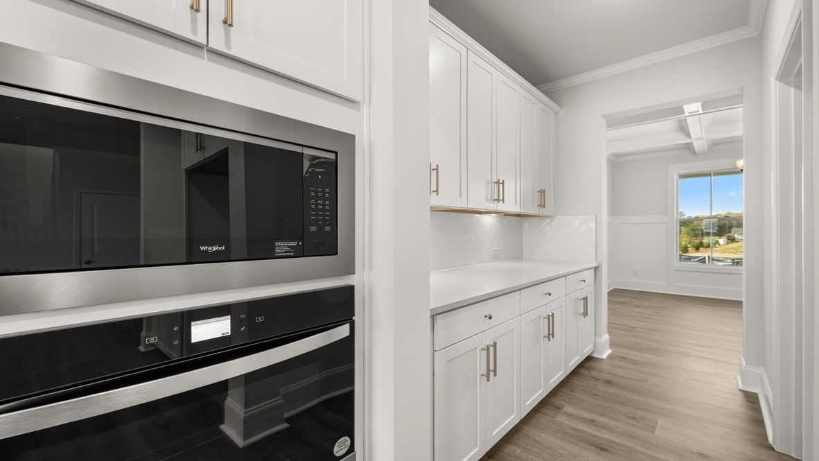 Interior kitchen with center island and white cabinets