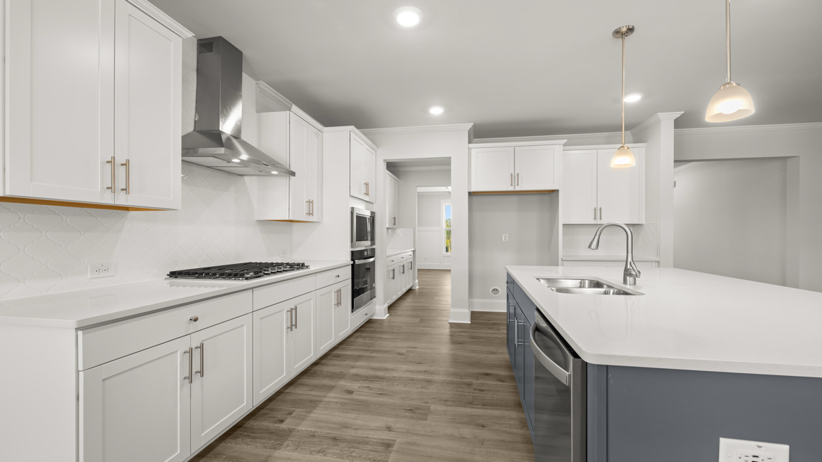 Interior kitchen with center island and white cabinets