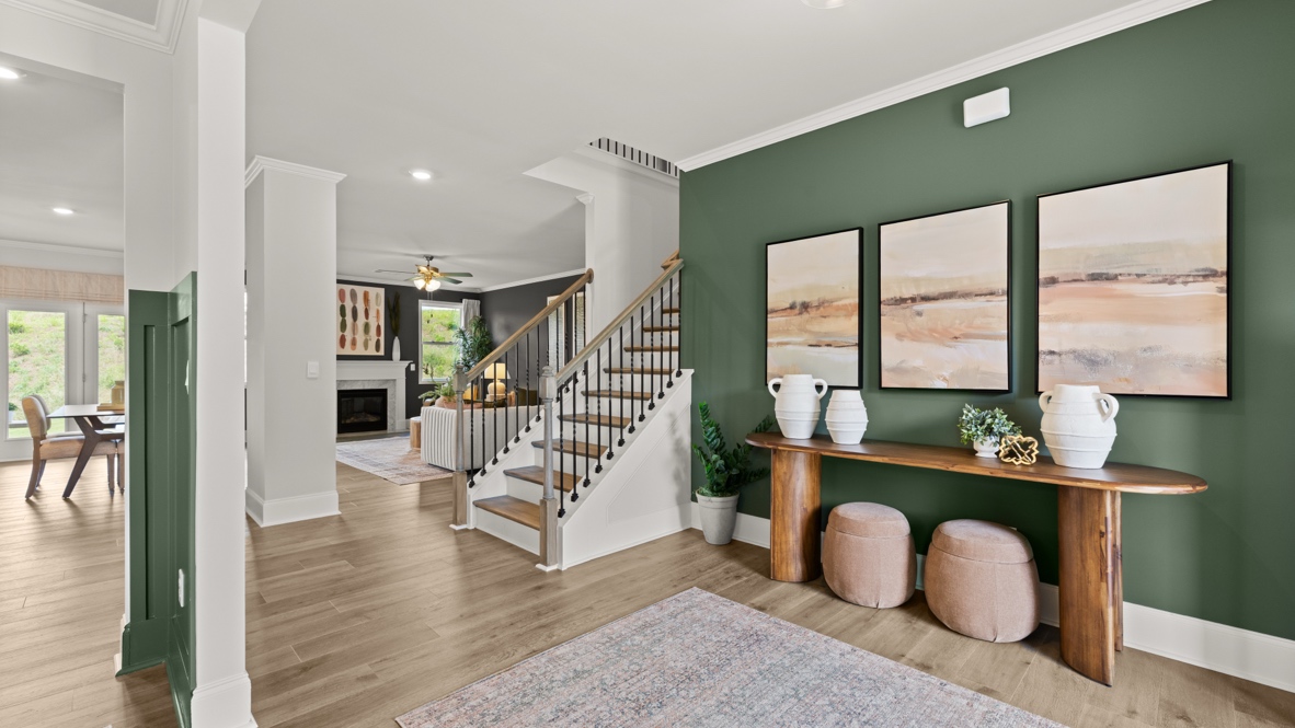 front entry way of home featuring brown flooring and white walls