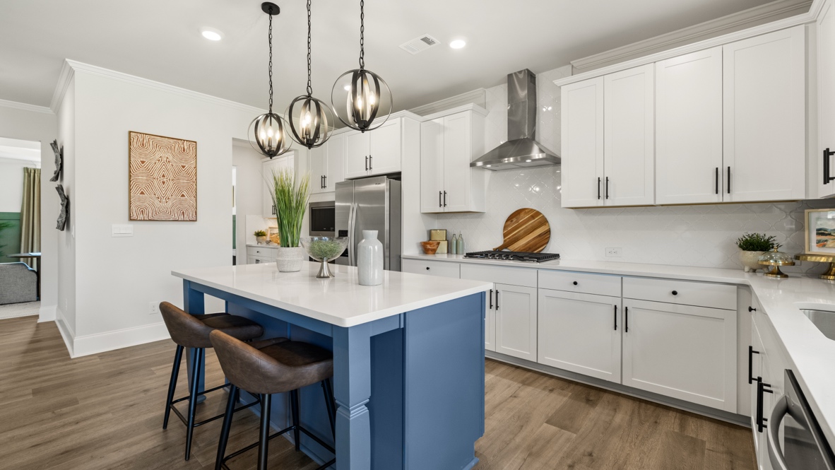 kitchen with white cabinetry, large island, and stainless steel appliances