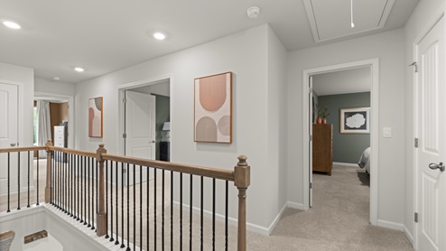 Upstairs hallway of home with carpeted floors.