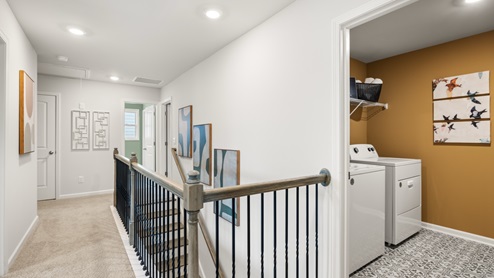 Laundry room conveniently placed upstairs near bedrooms.