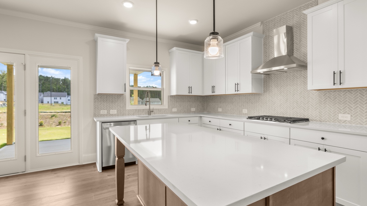 Interior kitchen with center island and white cabinets