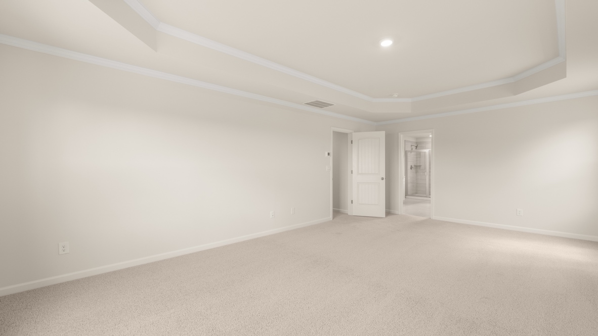 Interior primary bedroom with windows