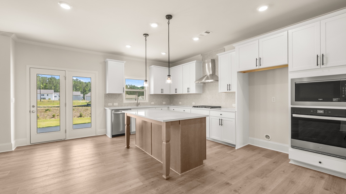 Interior kitchen with center island and white cabinets