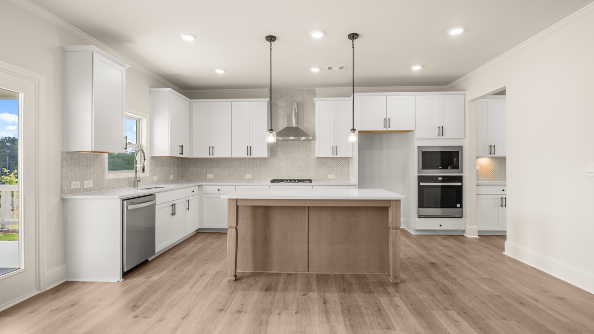 Interior kitchen with center island and white cabinets