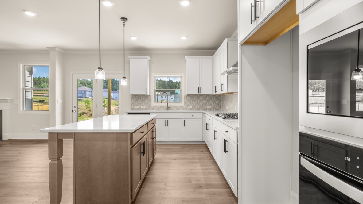 Interior kitchen with center island and white cabinets