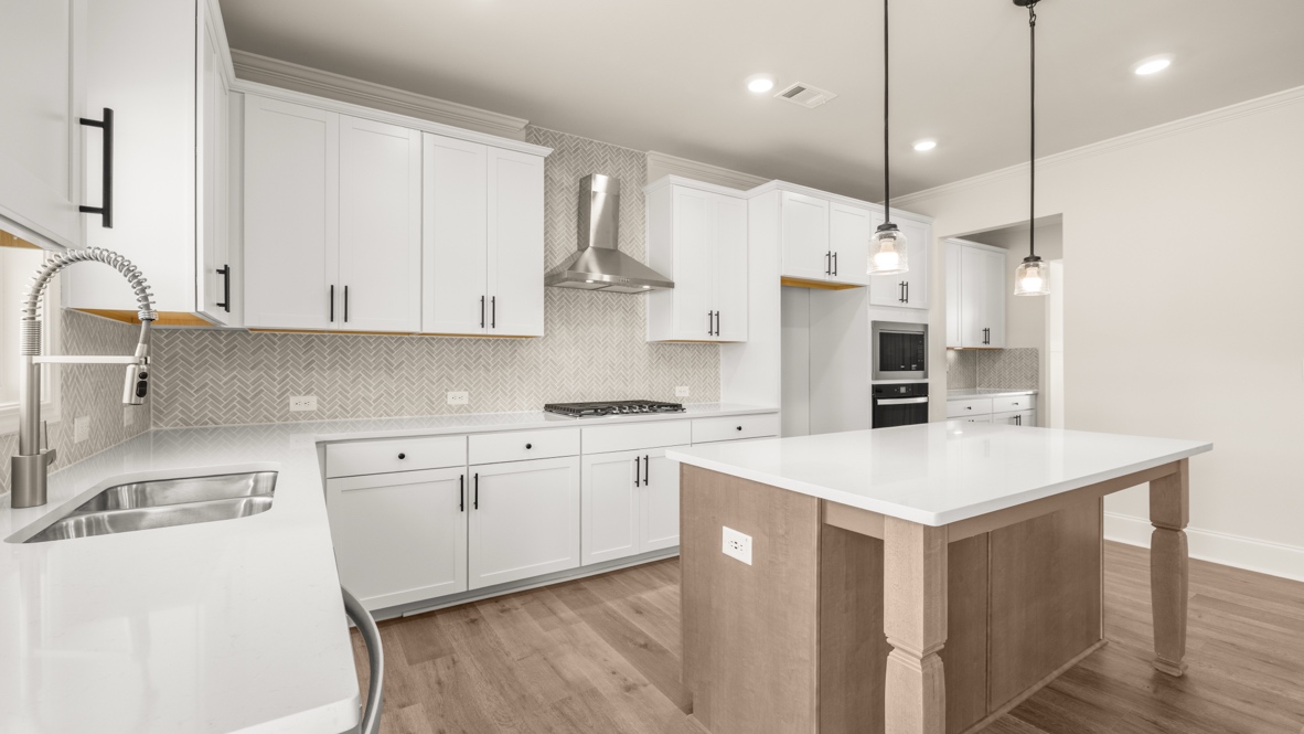 Interior kitchen with center island and white cabinets