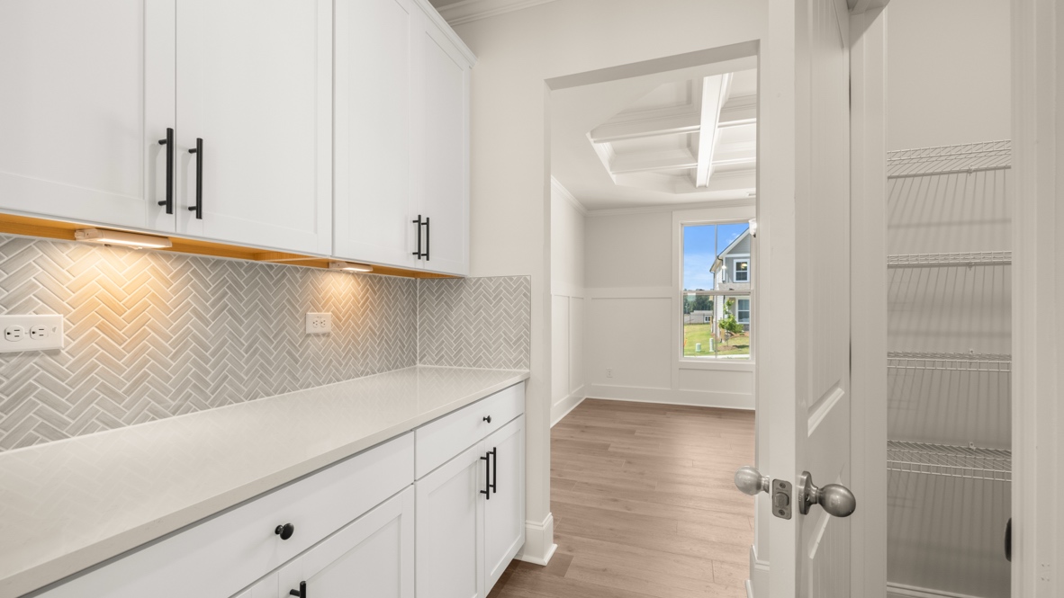 Interior kitchen with center island and white cabinets