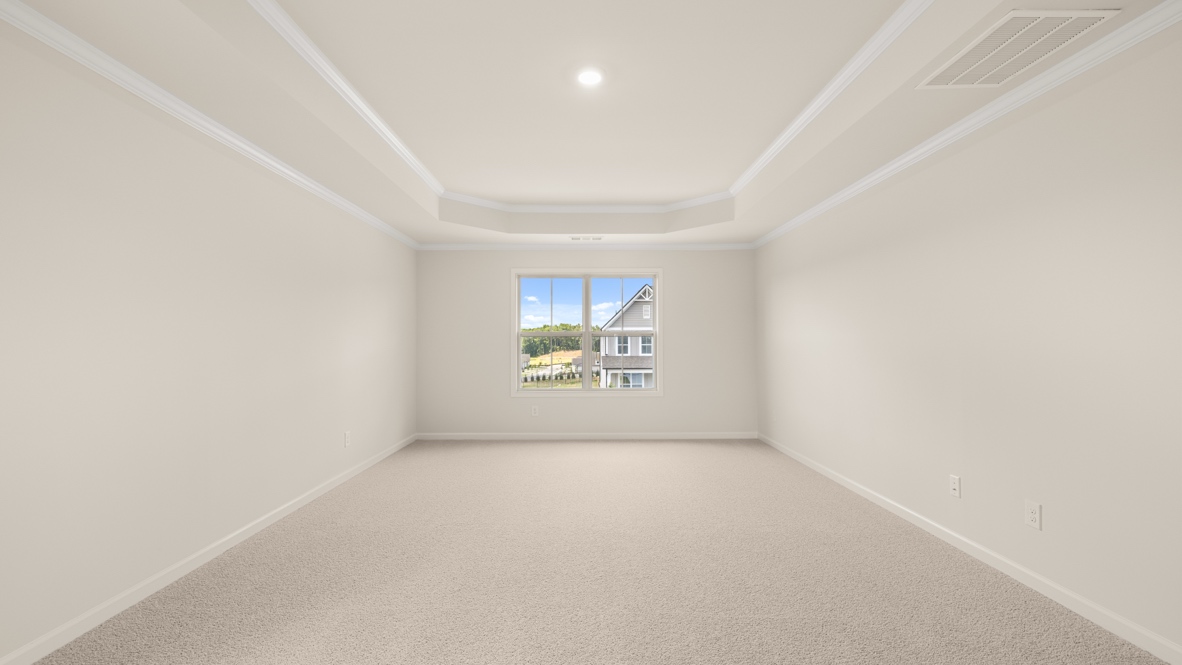 Interior primary bedroom with large window