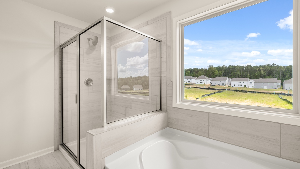 Interior primary bathroom with shower and bath tub