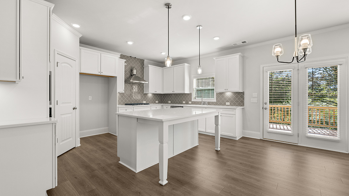Interior kitchen with center island and white cabinets