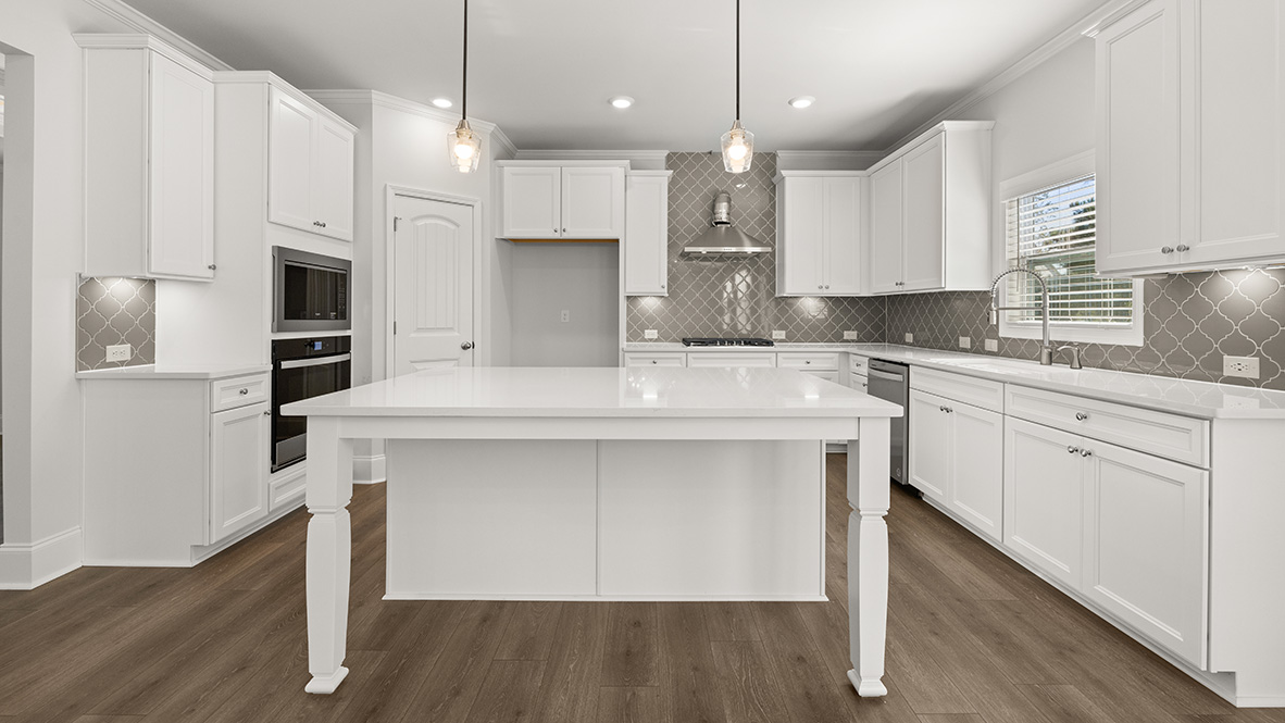 Interior kitchen with center island and white cabinets