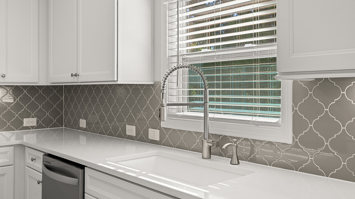 Interior kitchen with center island and white cabinets