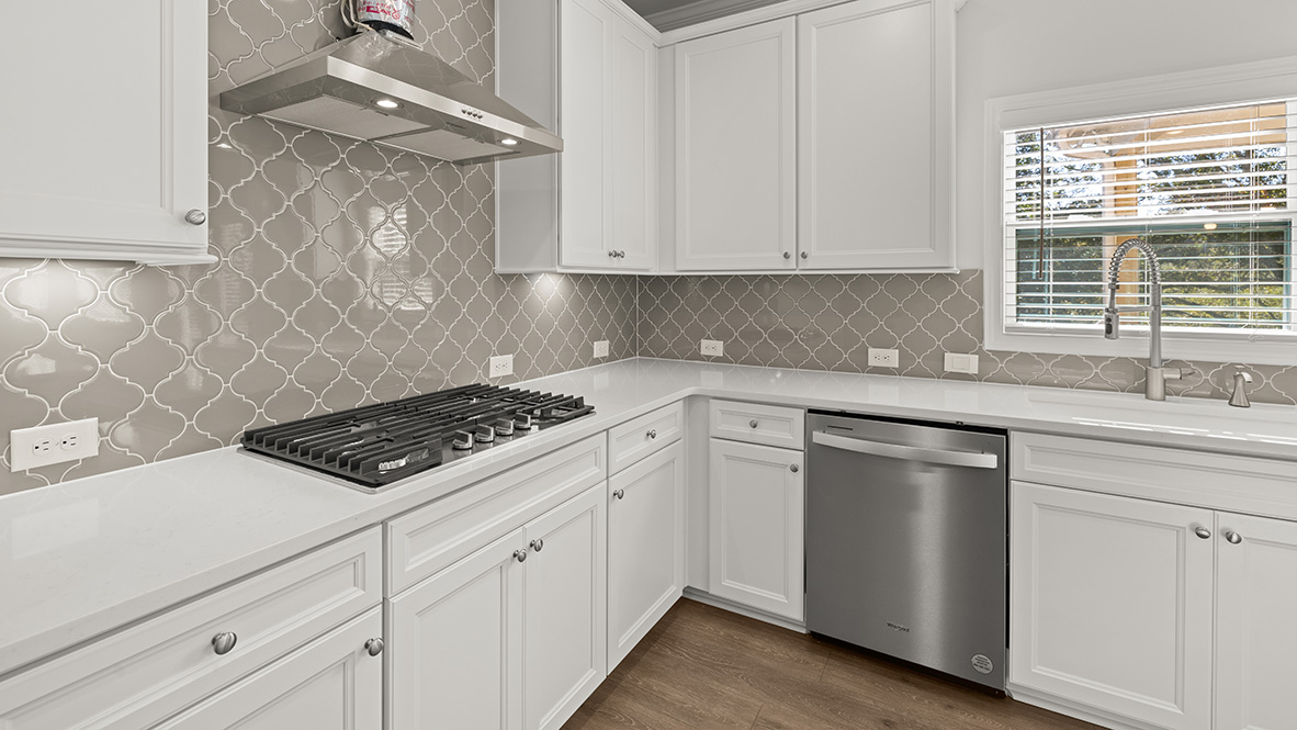 Interior kitchen with center island and white cabinets