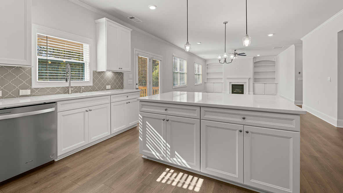 Interior kitchen with center island and white cabinets